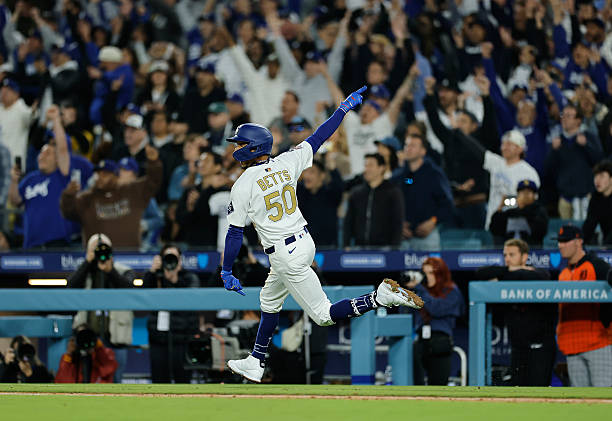 Mookie Betts celebrates a three-run walk-off homer in the 10th inning to lift the Dodgers to an 8-5 win over the Detroit Tigers on Friday night.